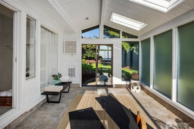 sunroom with a skylight and beamed ceiling