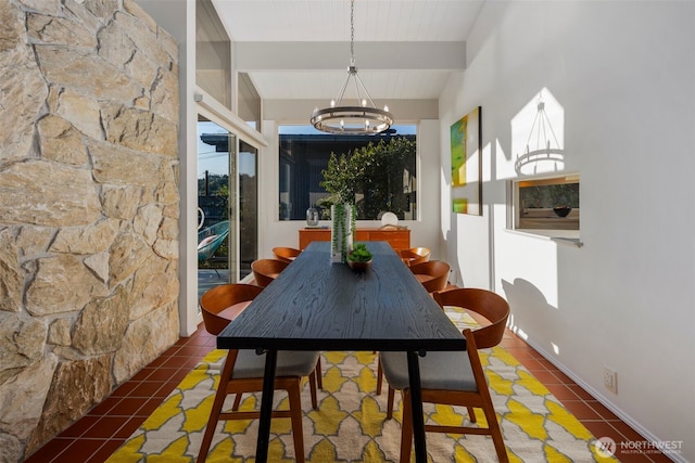 tiled dining area featuring an inviting chandelier and vaulted ceiling with beams