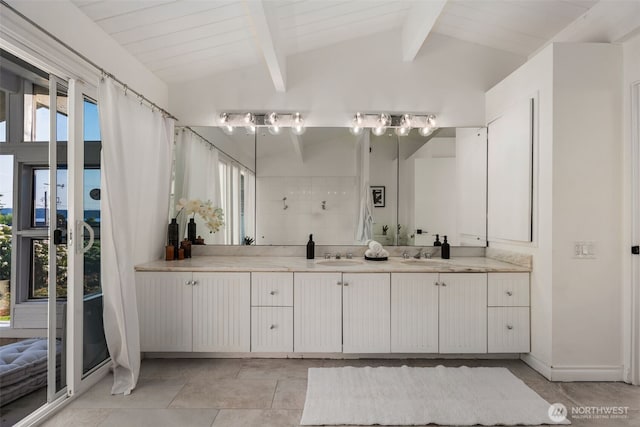 bathroom featuring vanity and lofted ceiling with beams