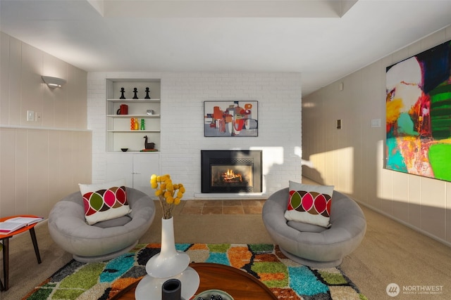 rec room featuring carpet floors, a fireplace, and built in shelves