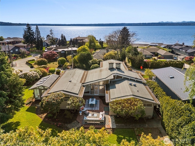drone / aerial view featuring a residential view and a water view