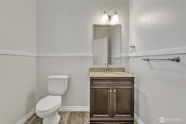24204 SE 278th St, Maple Valley, WA 98038 - half bathroom featuring toilet, wood finished floors, vanity, and baseboards