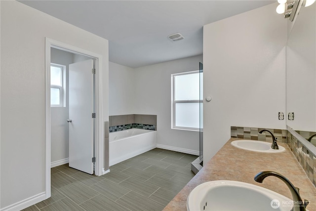 24204 SE 278th St, Maple Valley, WA 98038 - bathroom with baseboards, a bath, and double vanity
