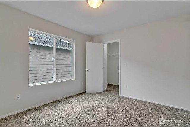 24204 SE 278th St, Maple Valley, WA 98038 - unfurnished bedroom with carpet floors, baseboards, and a walk in closet