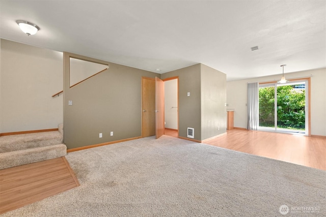 4243 Wintergreen Cir Unit 134, Bellingham, WA 98226 - unfurnished living room featuring carpet floors, baseboards, stairs, and visible vents