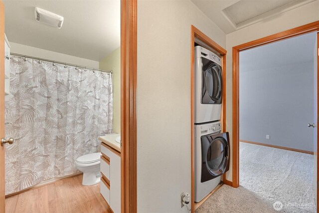 4243 Wintergreen Cir Unit 134, Bellingham, WA 98226 - full bathroom with vanity, toilet, baseboards, stacked washer / dryer, and visible vents