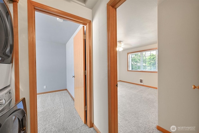 4243 Wintergreen Cir Unit 134, Bellingham, WA 98226 - hallway featuring carpet floors, stacked washer and clothes dryer, baseboards, and visible vents