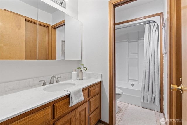 bathroom featuring tile patterned floors, shower / bath combo with shower curtain, vanity, and toilet