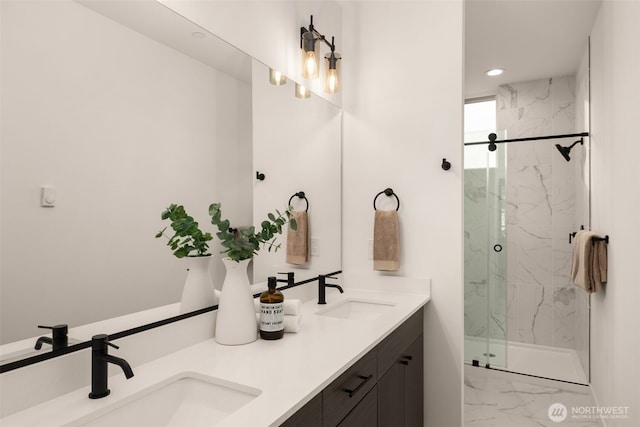 bathroom featuring a sink, a marble finish shower, and marble finish floor