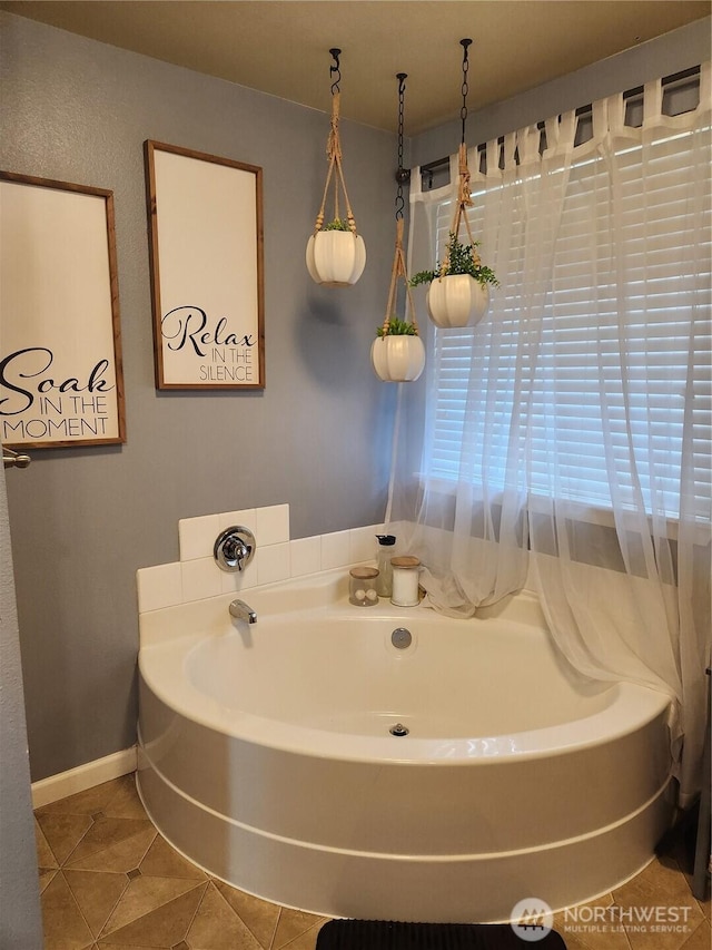9244 Carys St SE, Yelm, WA 98597 - bathroom with a bath, baseboards, and tile patterned floors