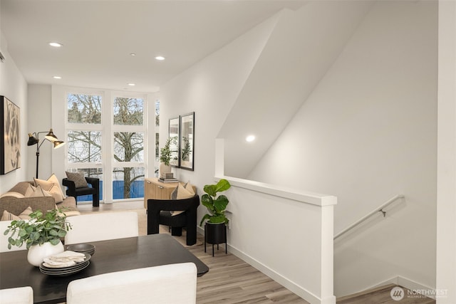 dining space featuring light wood finished floors, baseboards, and recessed lighting