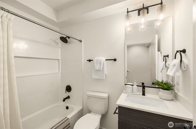 bathroom featuring toilet, vanity, and shower / bath combination with curtain