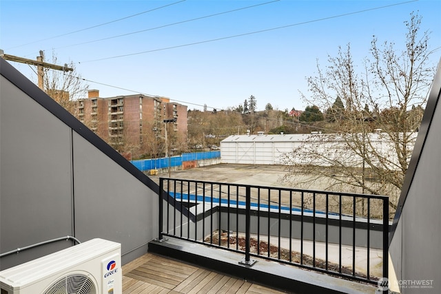 wooden deck featuring ac unit