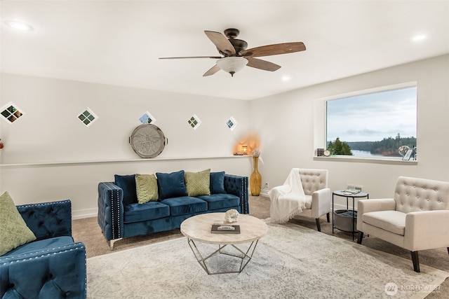 carpeted living area featuring baseboards, a ceiling fan, visible vents, and recessed lighting