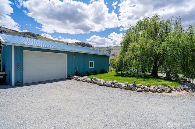 876 1st St, Chelan Falls, WA 98817 - view of side of home featuring a yard, an outbuilding, a detached garage, and metal roof
