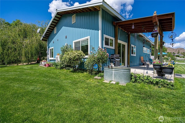 876 1st St, Chelan Falls, WA 98817 - rear view of property featuring a patio area and a lawn