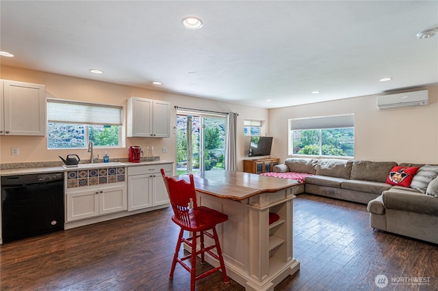 876 1st St, Chelan Falls, WA 98817 - kitchen with dishwasher, a wall unit AC, dark wood-style flooring, open floor plan, and recessed lighting