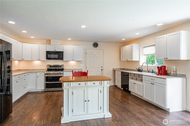876 1st St, Chelan Falls, WA 98817 - kitchen with black appliances, a sink, dark wood finished floors, a kitchen island, and recessed lighting