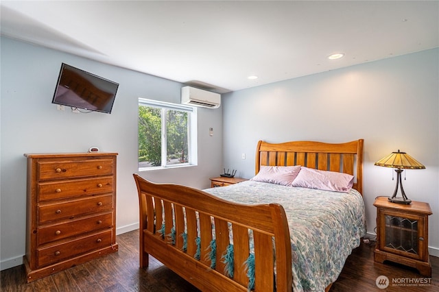 876 1st St, Chelan Falls, WA 98817 - bedroom featuring an AC wall unit, wood finished floors, recessed lighting, and baseboards