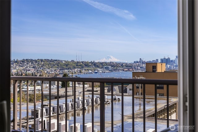 balcony featuring a city view and a mountain view