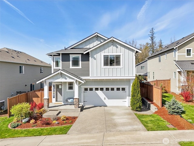 view of front of house with a garage, board and batten siding, fence, and concrete driveway