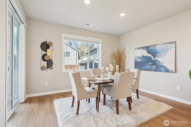 dining space featuring wood finished floors, baseboards, visible vents, and recessed lighting