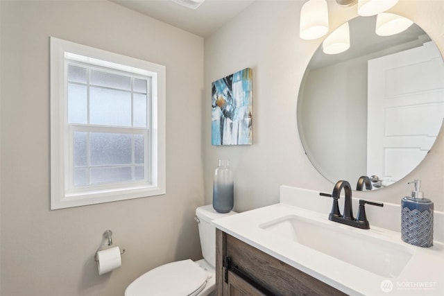 half bath featuring toilet and vanity