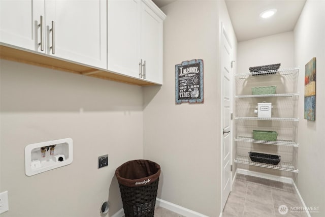washroom featuring light tile patterned floors, hookup for an electric dryer, washer hookup, baseboards, and cabinet space