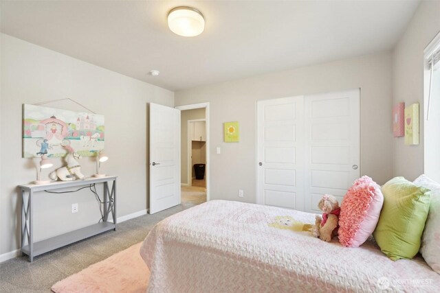 bedroom with light colored carpet and baseboards