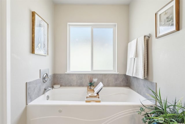 full bathroom featuring a bath and a wealth of natural light
