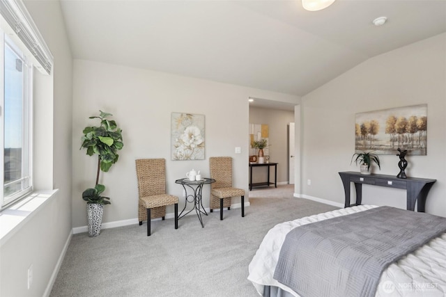 bedroom featuring light colored carpet, multiple windows, and lofted ceiling