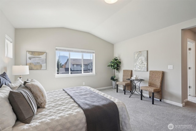 carpeted bedroom with baseboards and lofted ceiling