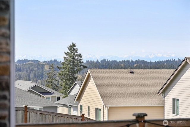 exterior space with a forest view and fence