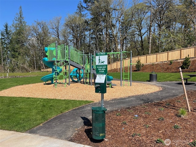 community jungle gym with a lawn and fence