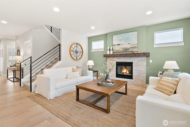 14232 SE 284th Pl, Kent, WA 98042 - living area featuring recessed lighting, a glass covered fireplace, light wood finished floors, and stairs
