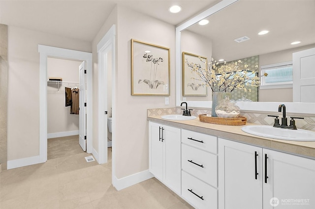 14232 SE 284th Pl, Kent, WA 98042 - bathroom featuring a spacious closet, double vanity, visible vents, and a sink