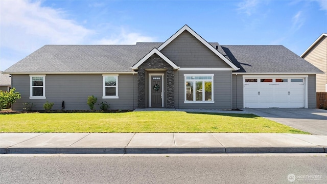 131 NW Blalock Dr, College Place, WA 99324 - craftsman-style house with a shingled roof, a garage, a front yard, and driveway