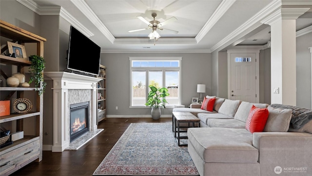 131 NW Blalock Dr, College Place, WA 99324 - living room featuring ceiling fan, a glass covered fireplace, ornamental molding, dark wood-style flooring, and a raised ceiling