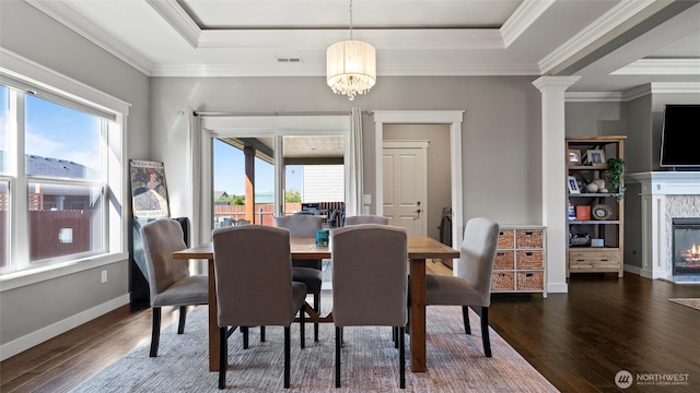 131 NW Blalock Dr, College Place, WA 99324 - dining area featuring a wealth of natural light, a glass covered fireplace, a tray ceiling, and wood finished floors