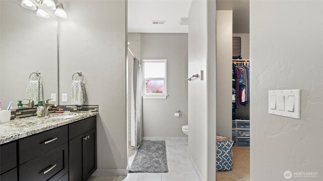 131 NW Blalock Dr, College Place, WA 99324 - full bathroom featuring vanity, a stall shower, a spacious closet, toilet, and visible vents