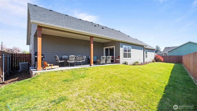 131 NW Blalock Dr, College Place, WA 99324 - back of house with a patio, a fenced backyard, roof with shingles, and a lawn