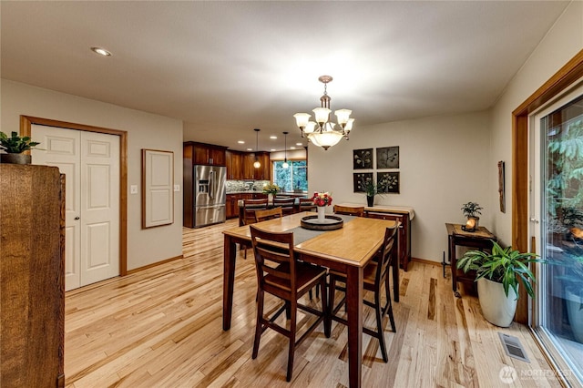dining room with visible vents, baseboards, an inviting chandelier, light wood-type flooring, and recessed lighting