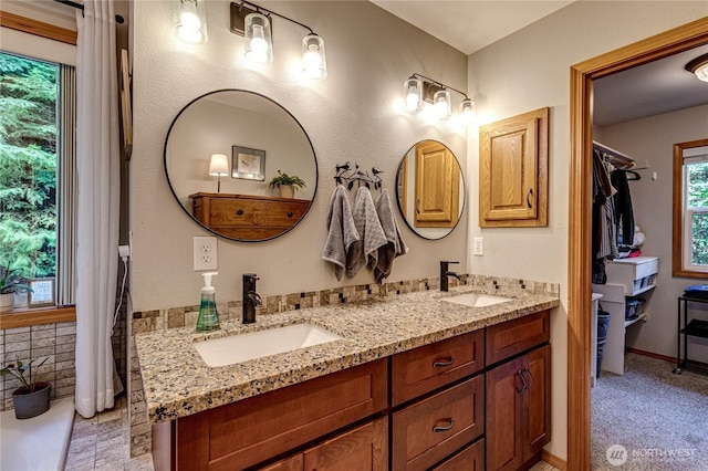 full bath with double vanity and a sink