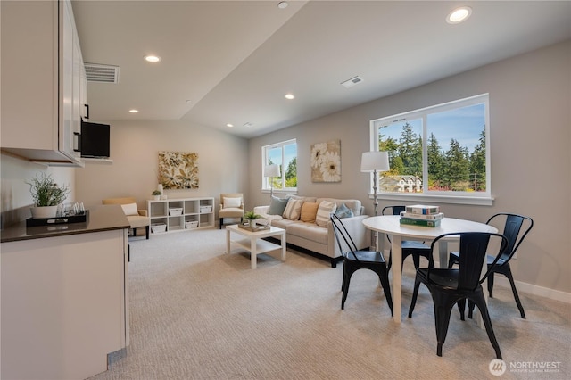 living room with light carpet, visible vents, and recessed lighting