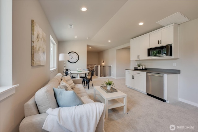 living area with recessed lighting, visible vents, baseboards, and light colored carpet