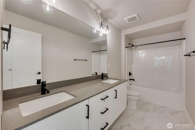 bathroom featuring marble finish floor, visible vents, toilet, and a sink