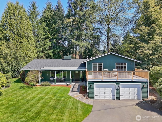24264 133rd Ave SE, Kent, WA 98042 - tri-level home with concrete driveway, a front lawn, an attached garage, and covered porch