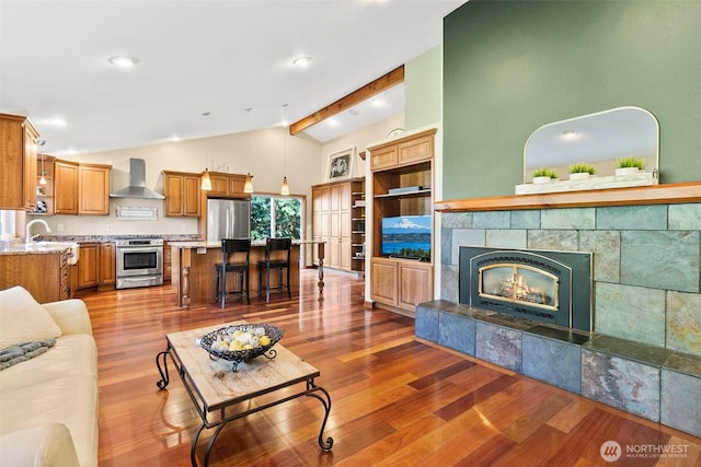 24264 133rd Ave SE, Kent, WA 98042 - living area with recessed lighting, light wood-type flooring, a tiled fireplace, and vaulted ceiling with beams
