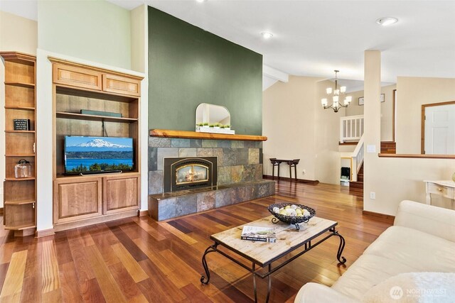24264 133rd Ave SE, Kent, WA 98042 - living area featuring lofted ceiling, wood finished floors, baseboards, a chandelier, and a tiled fireplace