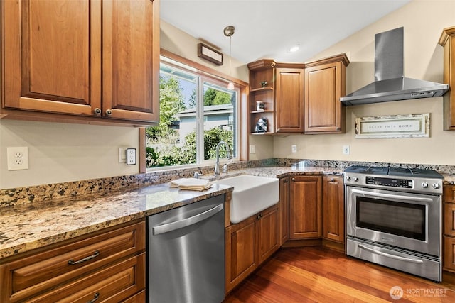 24264 133rd Ave SE, Kent, WA 98042 - kitchen featuring a sink, wood finished floors, wall chimney range hood, light stone countertops, and appliances with stainless steel finishes